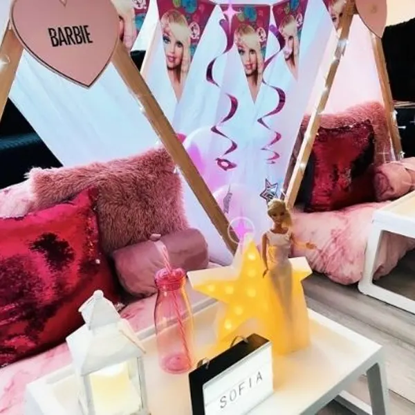 Barbie-themed teepees with pink bedding, cushions and bedside trays