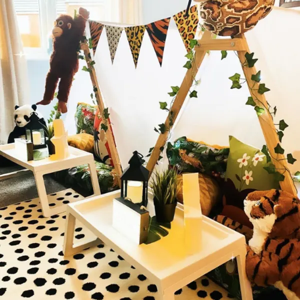Jungle-themed teepees with animal cushions and leafy decorations